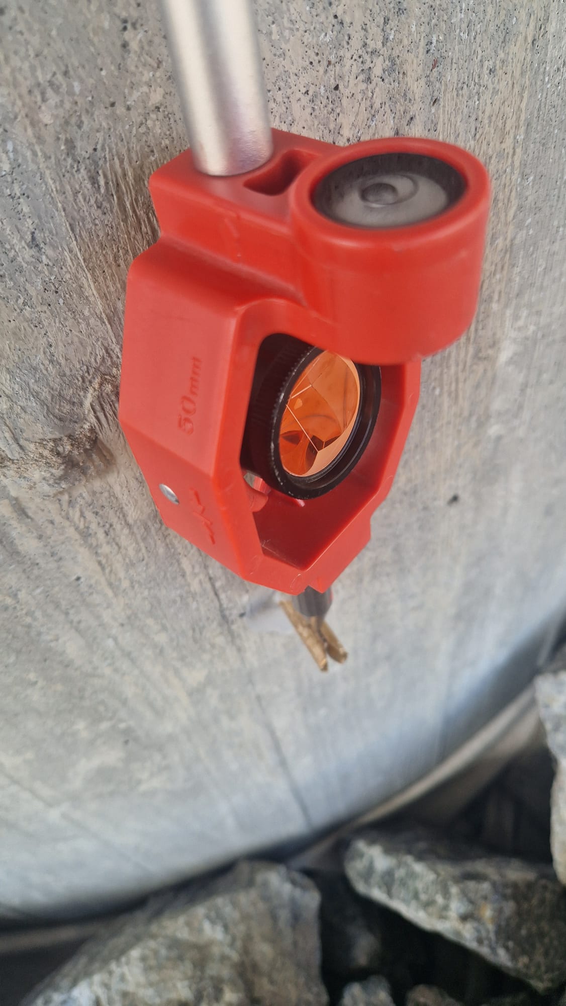 Close-up of a red surveying prism