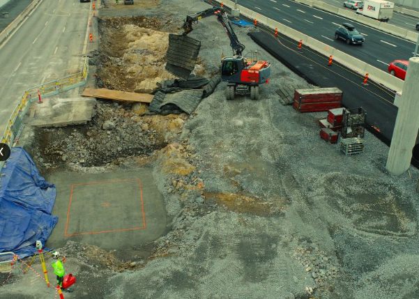 Aerial view of an excavation beside a live road